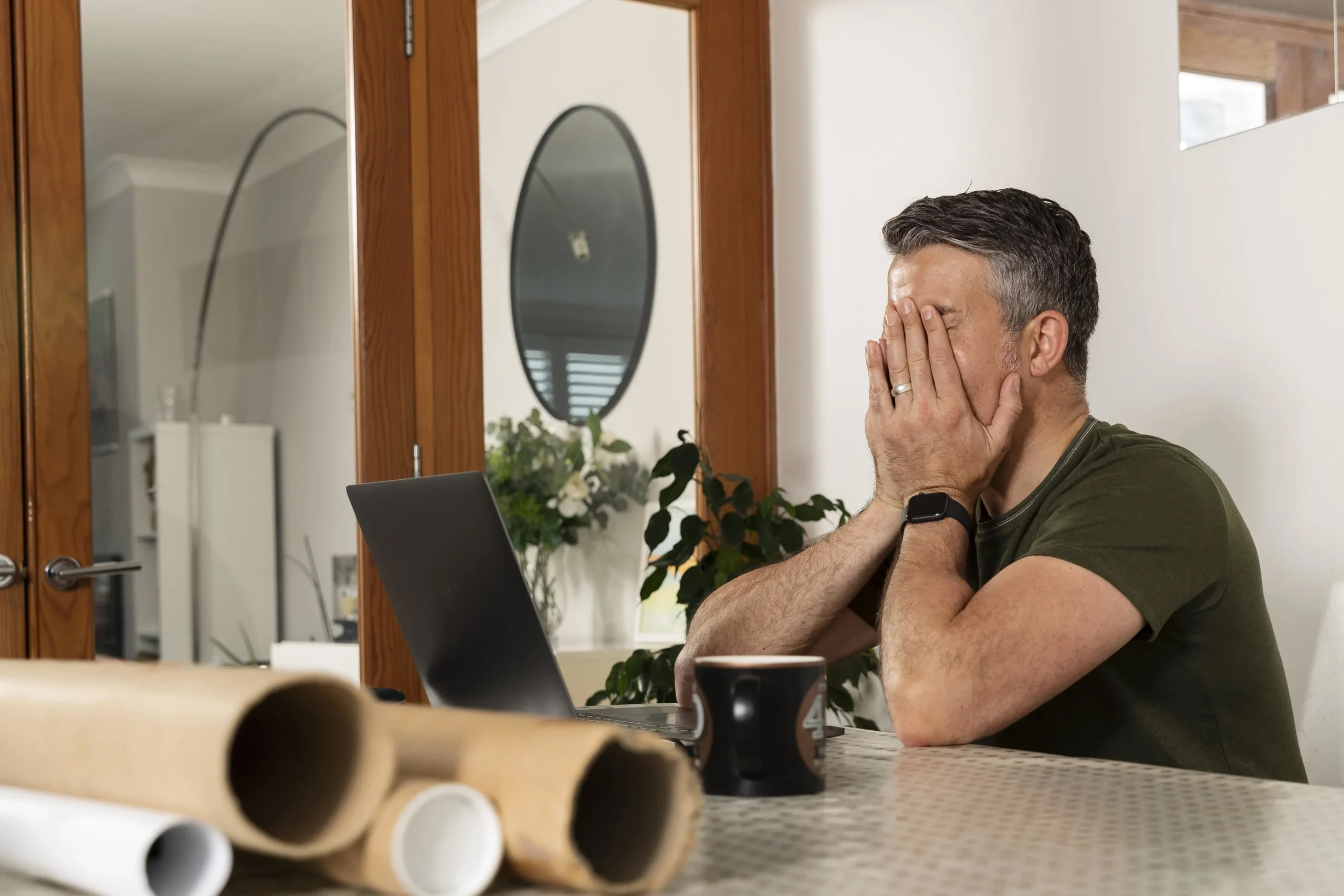 father-covering-his-face-with-his-hands